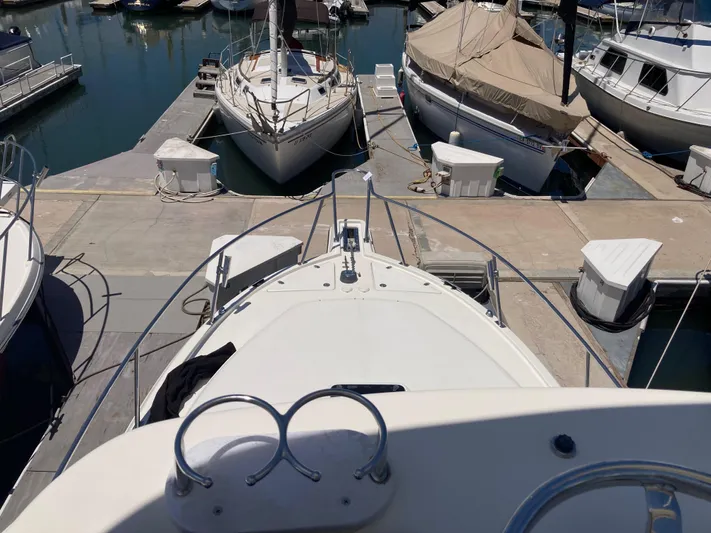 Alibi Yacht Photos Pics 2006 Rampage Express Offshore Tower docked at marina, surrounded by other boats.