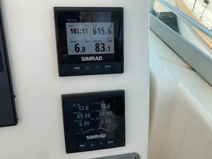 Alibi Yacht Photos Pics Simrad displays on 2006 Rampage Express Offshore Tower showing trip log and engine data.