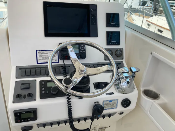 Alibi Yacht Photos Pics Helm of 2006 Rampage Express Offshore Tower with steering wheel and navigation controls.