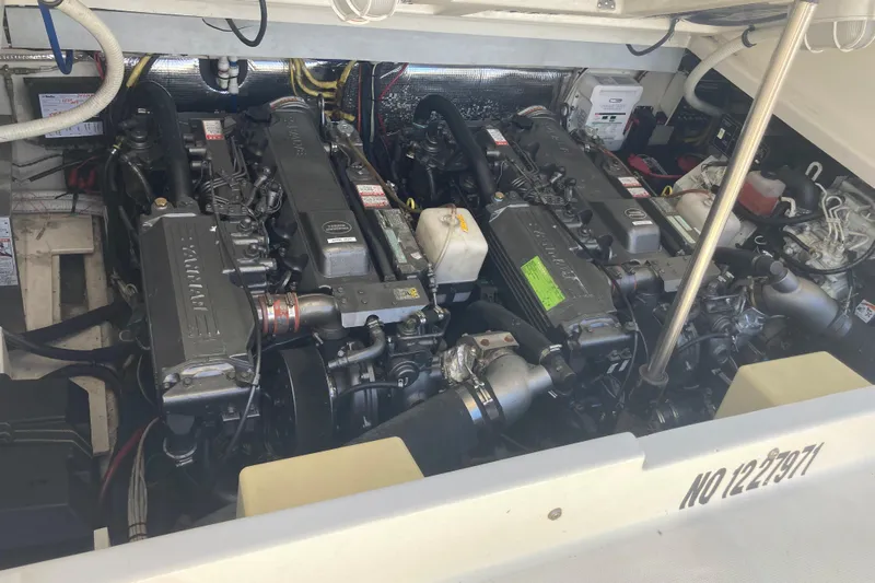 Alibi Yacht Photos Pics Engine room of a 2006 Rampage Express Offshore Tower boat, showcasing dual engines.