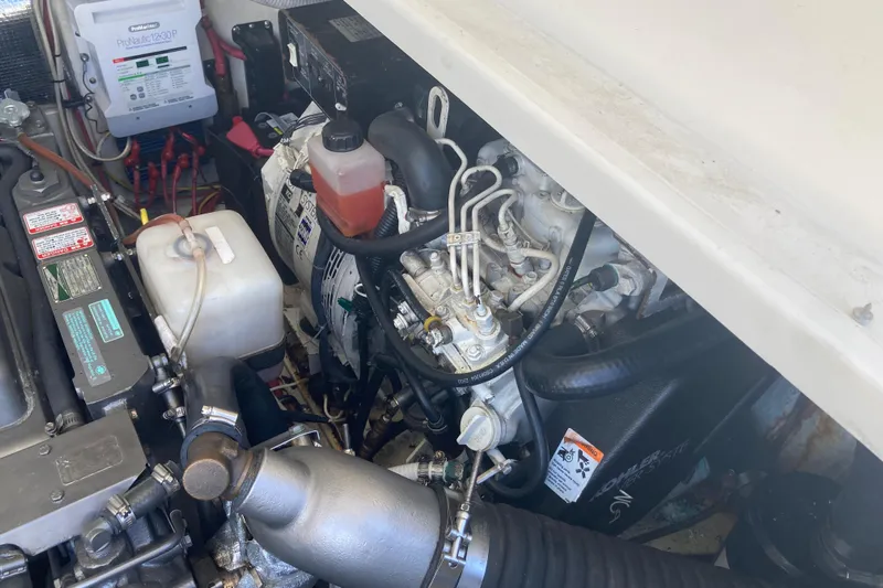 Alibi Yacht Photos Pics Engine compartment of a 2006 Rampage Express Offshore Tower boat, showcasing mechanical components.