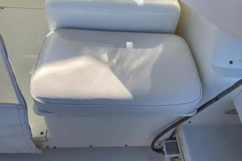 Alibi Yacht Photos Pics White cushioned seat on 2006 Rampage Express Offshore Tower boat.