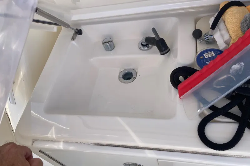 Alibi Yacht Photos Pics Sink area on a 2006 Rampage Express Offshore Tower boat with cleaning supplies.