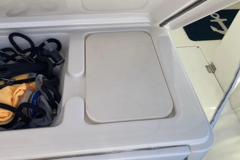 Alibi Yacht Photos Pics Storage compartment on a 2006 Rampage Express Offshore Tower boat with ropes and accessories.