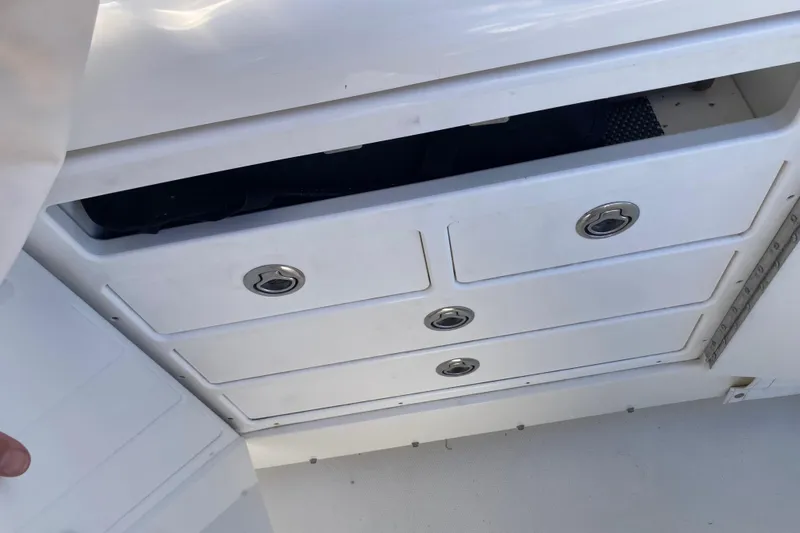 Alibi Yacht Photos Pics 2006 Rampage Express Offshore Tower boat storage drawers, partially open, white finish.
