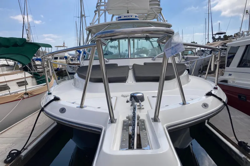 Alibi Yacht Photos Pics 2006 Rampage Express Offshore Tower boat docked at marina, featuring sleek design and spacious deck.