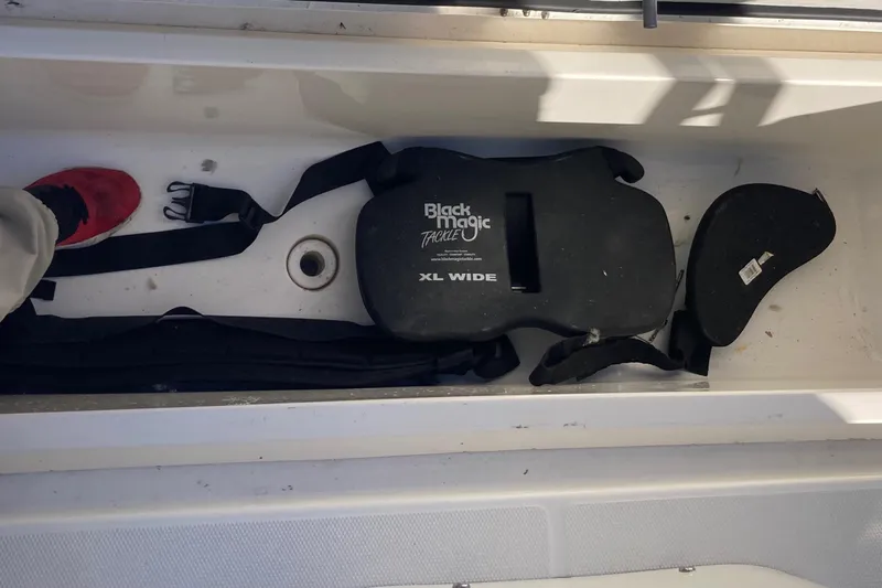 Alibi Yacht Photos Pics Storage compartment in a 2006 Rampage Express Offshore Tower with Black Magic tackle gear.