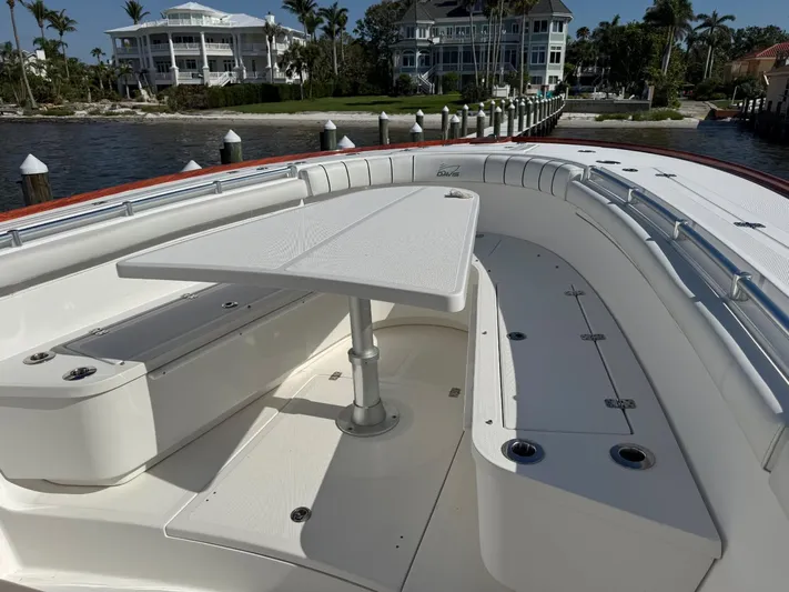 Yacht Photos Pics 2017 Buddy Davis 34 boat with spacious deck and seating area, docked near waterfront homes.