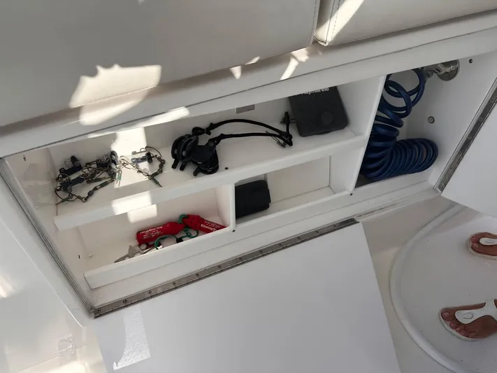  Yacht Photos Pics Storage compartment on a 2017 Buddy Davis 34 boat, containing various boating accessories.