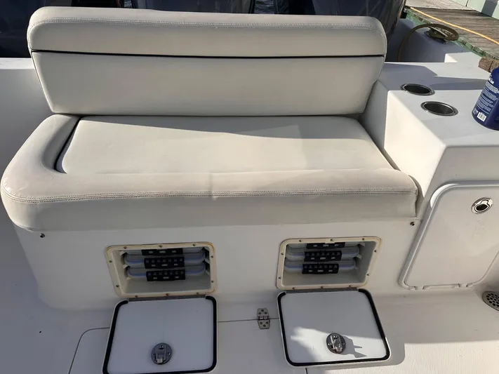  Yacht Photos Pics White cushioned seating on a 2017 Buddy Davis 34 boat with storage compartments.