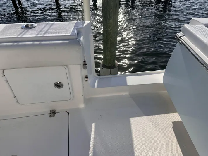 Yacht Photos Pics 2017 Buddy Davis 34 boat deck with water reflection and storage compartment.