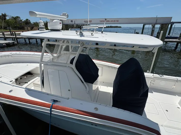  Yacht Photos Pics 2017 Buddy Davis 34 boat docked, featuring a sleek white design and covered seating.