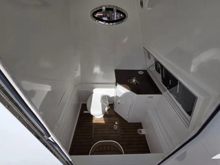  Yacht Photos Pics Interior of 2017 Buddy Davis 34 boat bathroom with wooden flooring and compact design.