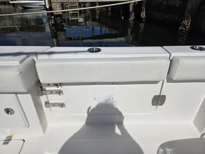  Yacht Photos Pics 2017 Buddy Davis 34 boat interior with white seating and cup holders, dockside view.
