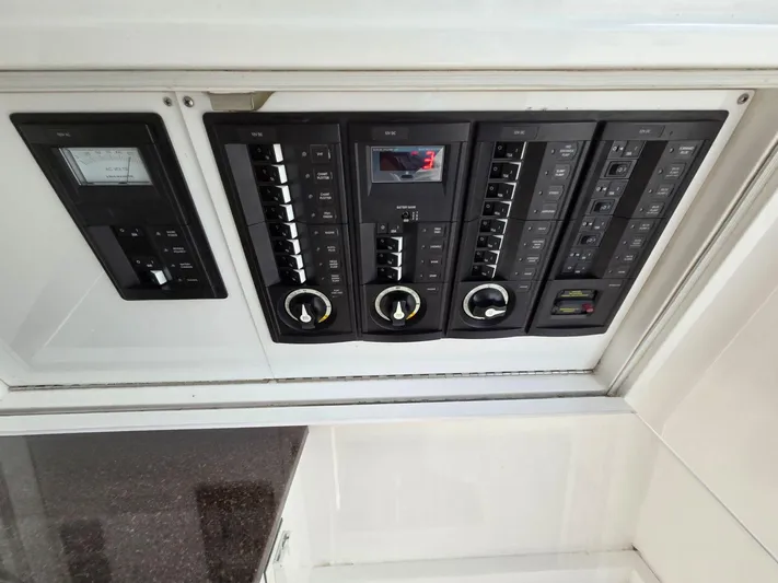  Yacht Photos Pics Electrical control panel on a 2017 Buddy Davis 34 boat, featuring switches and gauges.