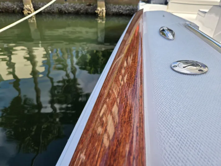  Yacht Photos Pics 2017 Buddy Davis 34 boat with polished wood detail by the water.