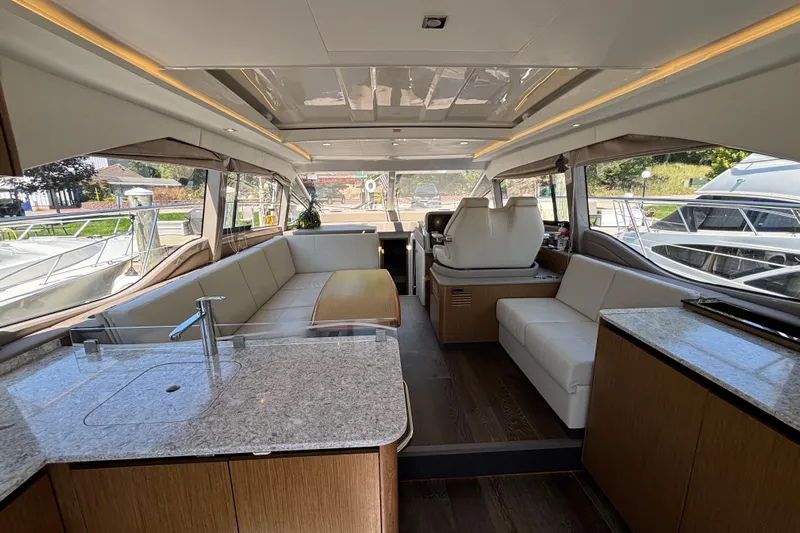 Cop Out II Yacht Photos Pics Luxurious interior of 2018 Sea Ray Sundancer 460 yacht with modern seating and kitchen area.