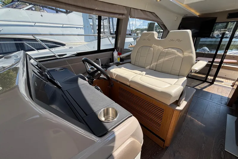 Cop Out II Yacht Photos Pics 2018 Sea Ray Sundancer 460 yacht interior with helm and plush seating.
