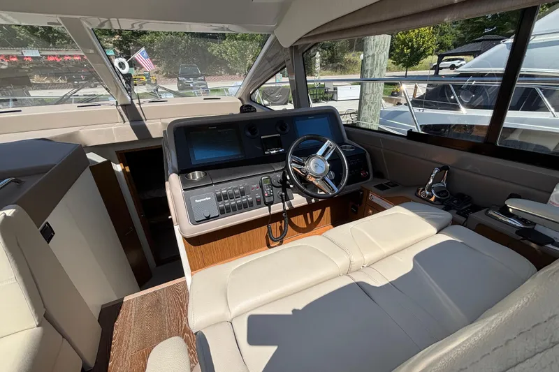 Cop Out II Yacht Photos Pics Interior of 2018 Sea Ray Sundancer 460 yacht, featuring helm with modern controls and leather seating.