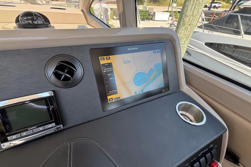 Cop Out II Yacht Photos Pics 2018 Sea Ray Sundancer 460 helm with navigation display and control panel.