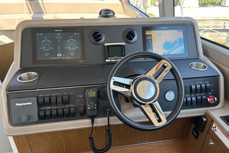 Cop Out II Yacht Photos Pics Helm of 2018 Sea Ray Sundancer 460 with Raymarine navigation displays and controls.