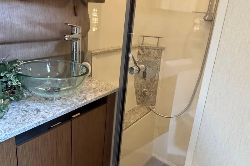 Cop Out II Yacht Photos Pics Luxurious bathroom in 2018 Sea Ray Sundancer 460 yacht with glass sink and modern shower.