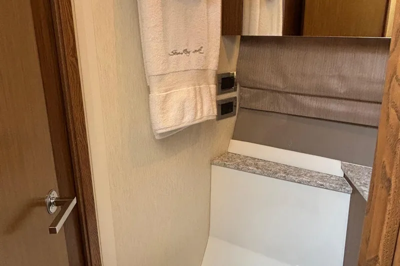 Cop Out II Yacht Photos Pics Interior of 2018 Sea Ray Sundancer 460 yacht, featuring elegant bathroom design with towel and mirror.