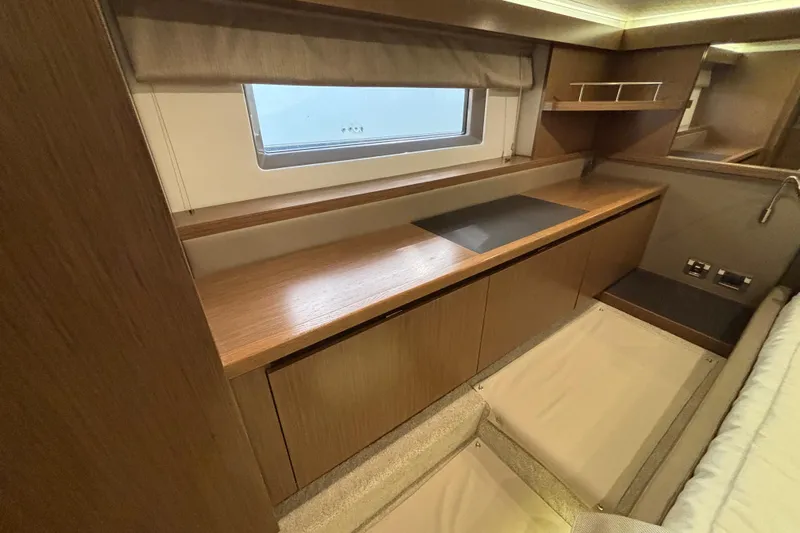 Cop Out II Yacht Photos Pics 2018 Sea Ray Sundancer 460 interior with wooden cabinetry and window view.