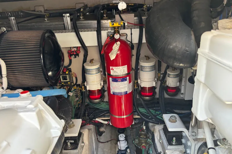 Cop Out II Yacht Photos Pics Engine room of 2018 Sea Ray Sundancer 460 with fire extinguisher and filters.
