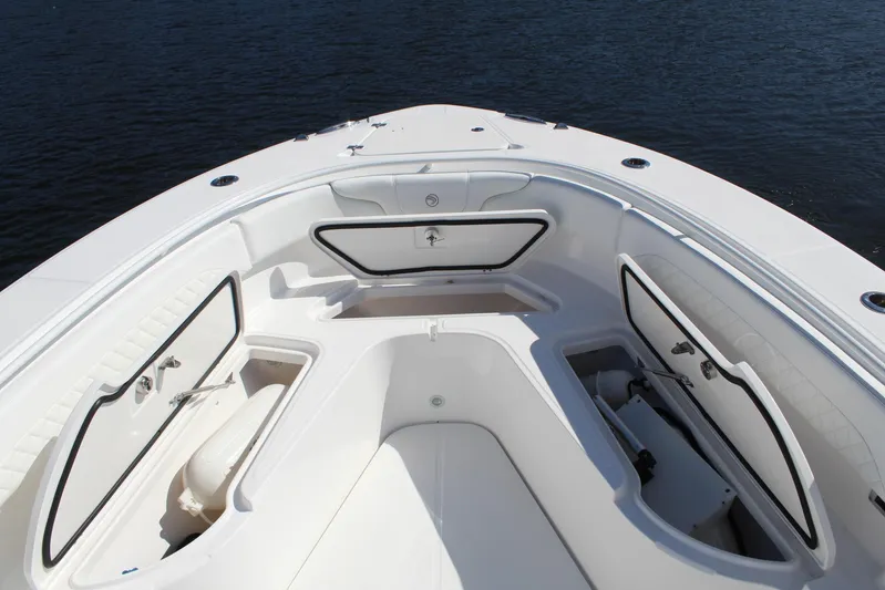  Yacht Photos Pics 2019 Edgewater 370CC boat deck with open storage compartments on calm water.