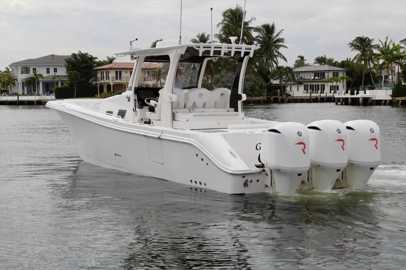  Yacht Photos Pics 2019 Edgewater 370CC boat with triple engines on a calm waterway.