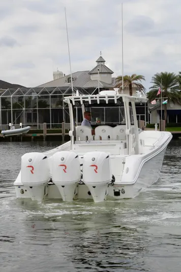  Yacht Photos Pics 2019 Edgewater 370CC boat with triple outboard engines on a calm waterway.