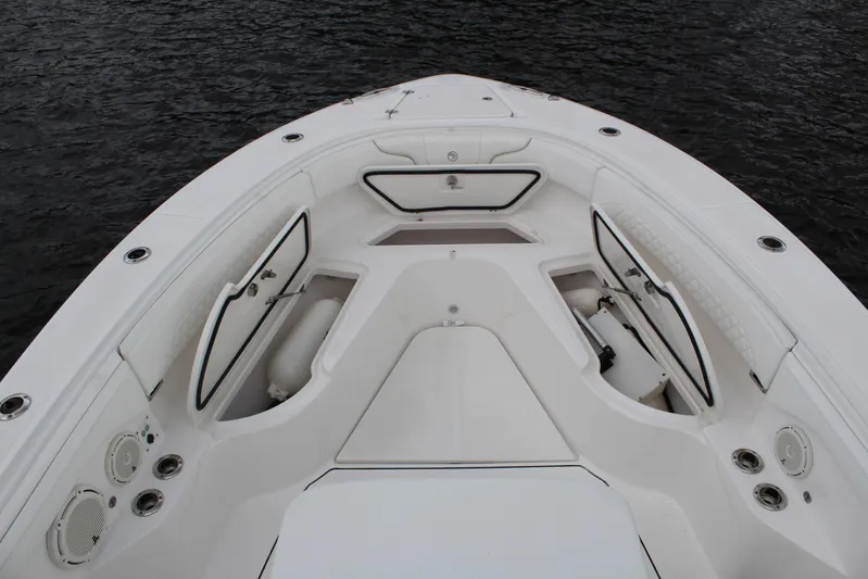  Yacht Photos Pics 2019 Edgewater 370CC boat deck with open storage compartments on calm water.