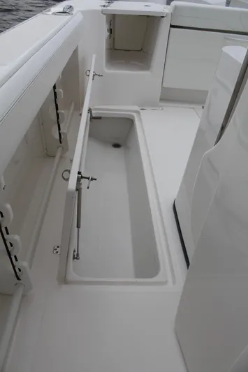  Yacht Photos Pics 2019 Edgewater 370CC boat interior with open storage compartment.