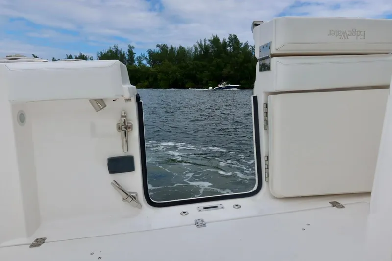  Yacht Photos Pics 2019 Edgewater 370CC boat with open transom door, view of water and trees.