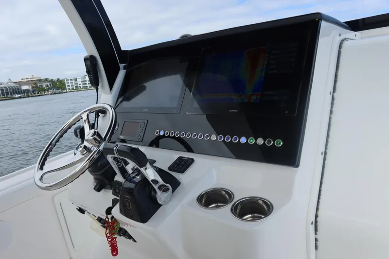  Yacht Photos Pics Edgewater 370CC 2019 boat dashboard with steering wheel and control panel.