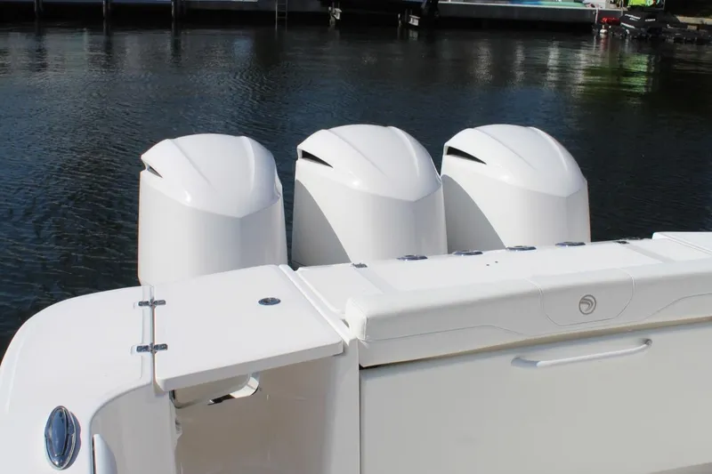  Yacht Photos Pics 2019 Edgewater 370CC boat with triple outboard engines on calm water.