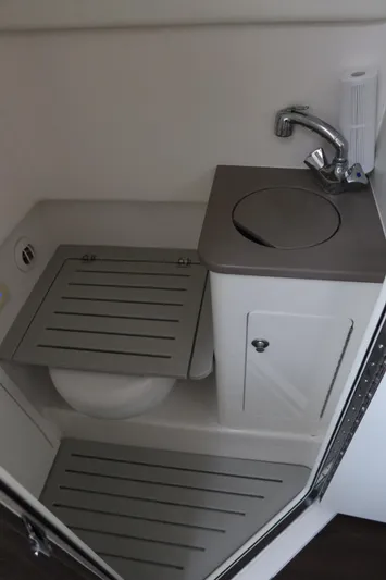  Yacht Photos Pics 2019 Edgewater 370CC boat bathroom with compact sink and toilet.