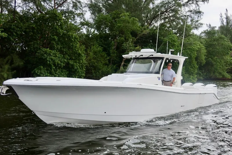  Yacht Photos Pics 2019 Edgewater 370CC boat cruising on a scenic waterway.
