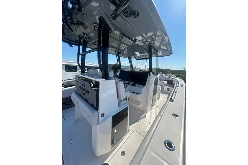  Yacht Photos Pics 2023 Fountain 38TE CC boat interior with modern helm and seating under clear blue sky.