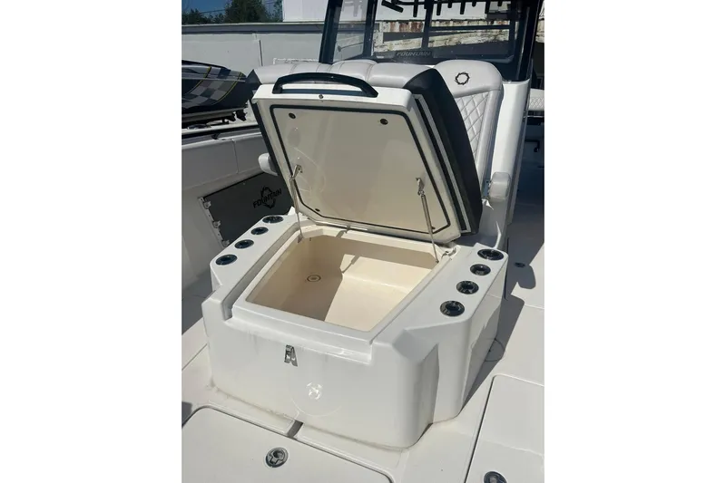  Yacht Photos Pics 2023 Fountain 38TE CC boat with open storage compartment and cup holders.