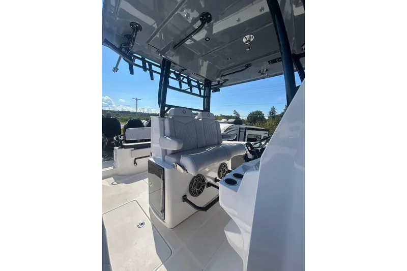  Yacht Photos Pics 2023 Fountain 38TE CC boat interior with seating and console, showcasing modern design.