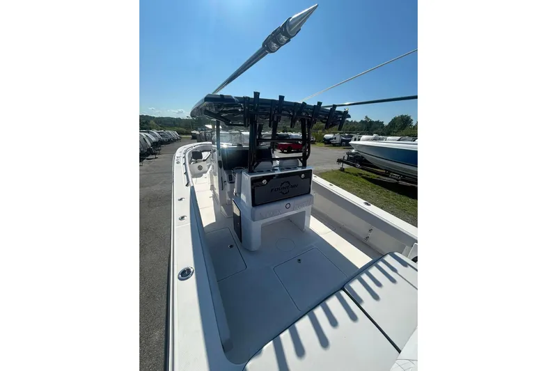  Yacht Photos Pics 2023 Fountain 38TE CC boat interior with seating and storage, parked outdoors under clear sky.
