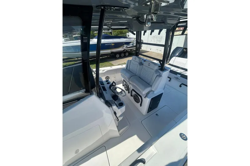  Yacht Photos Pics 2023 Fountain 38TE CC boat interior with seating and steering console.
