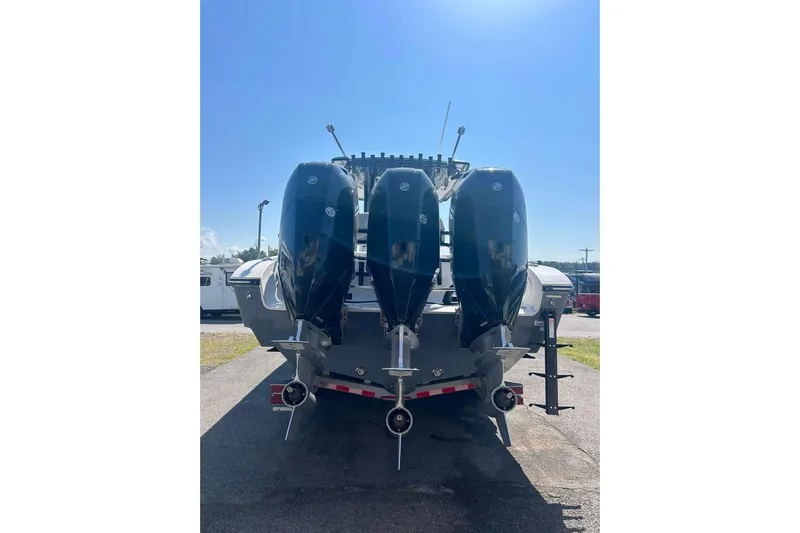  Yacht Photos Pics 2023 Fountain 38TE CC boat with triple outboard engines, rear view.