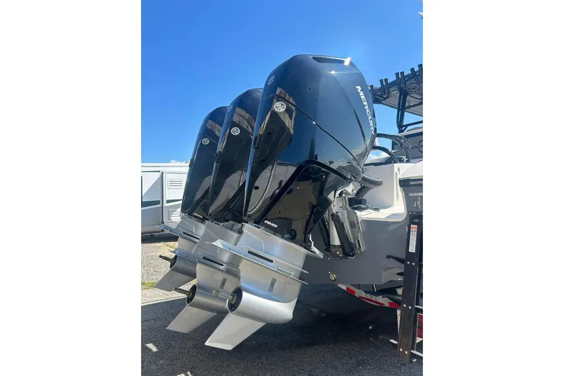  Yacht Photos Pics 2023 Fountain 38TE CC boat with triple Mercury outboard engines, parked outdoors.