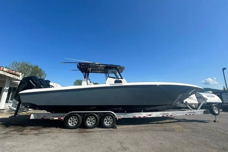  Yacht Photos Pics 2023 Fountain 38TE CC boat on trailer under clear blue sky.