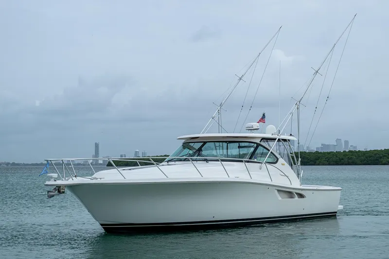 Wahoo Yacht Photos Pics 2009 Tiara Yachts 39 Open boat on calm water with city skyline in background.