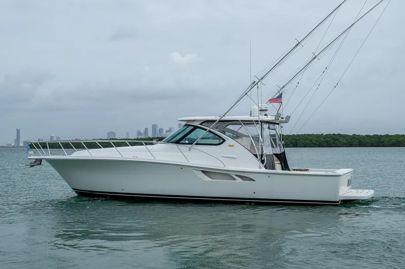 Wahoo Yacht Photos Pics 2009 Tiara Yachts 39 Open cruising on calm waters with city skyline in background.