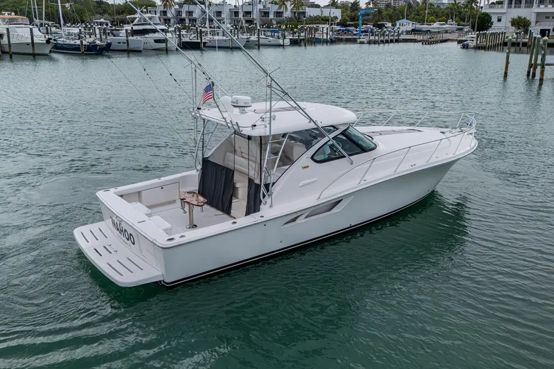 Wahoo Yacht Photos Pics 2009 Tiara Yachts 39 Open cruising in a marina, showcasing sleek design and fishing equipment.